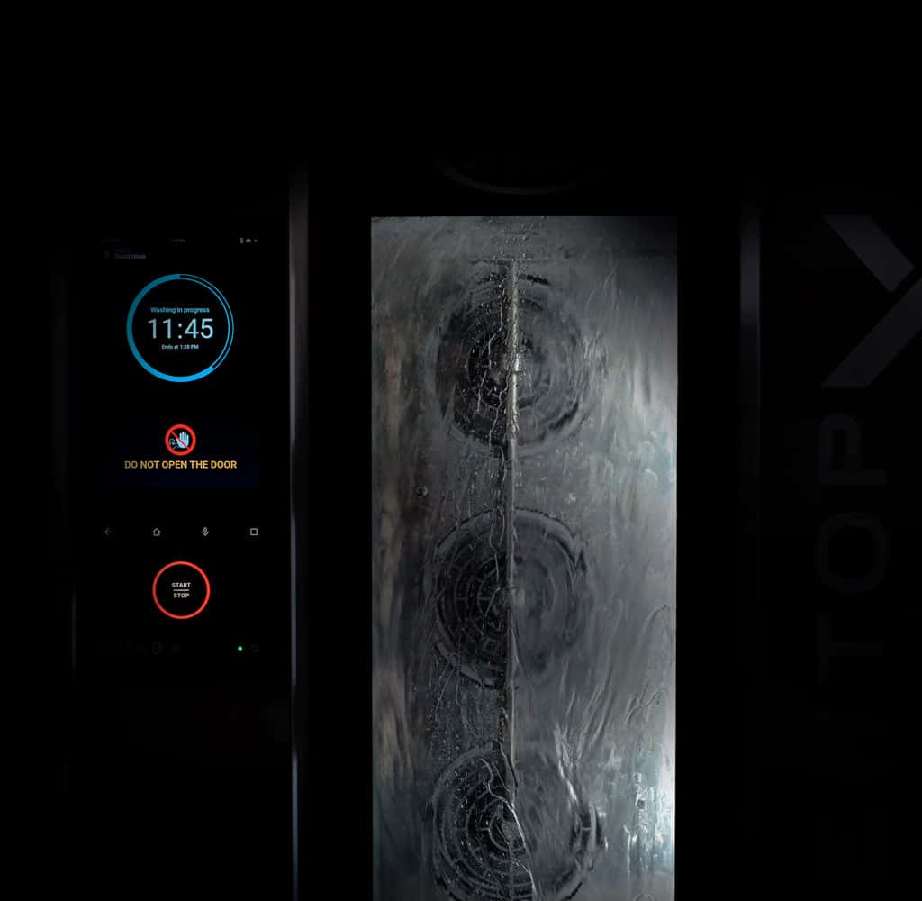 Unox self-cleaning commercial oven washing system in operation with the control panel on