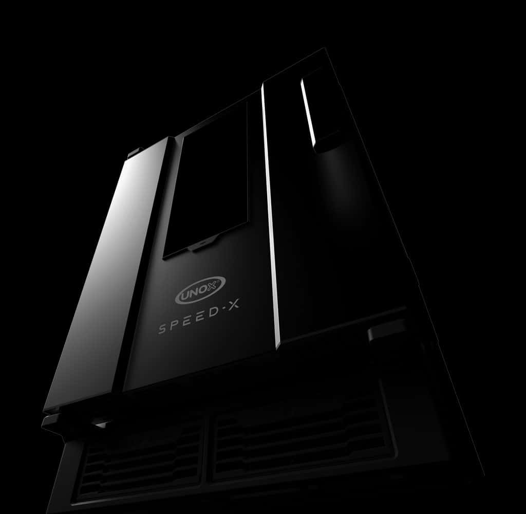 A dark, moody image of an Unox speed-x speed oven, lit so that only parts of the logo be seen. 